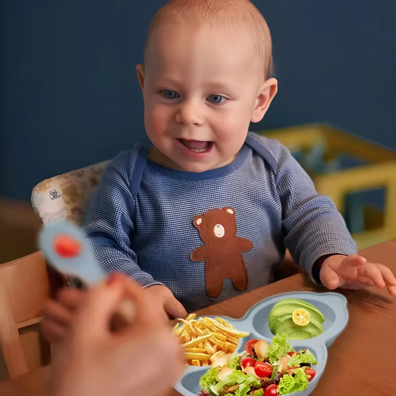 Utensílios de bebê. Babador, prato com divisória e talher.